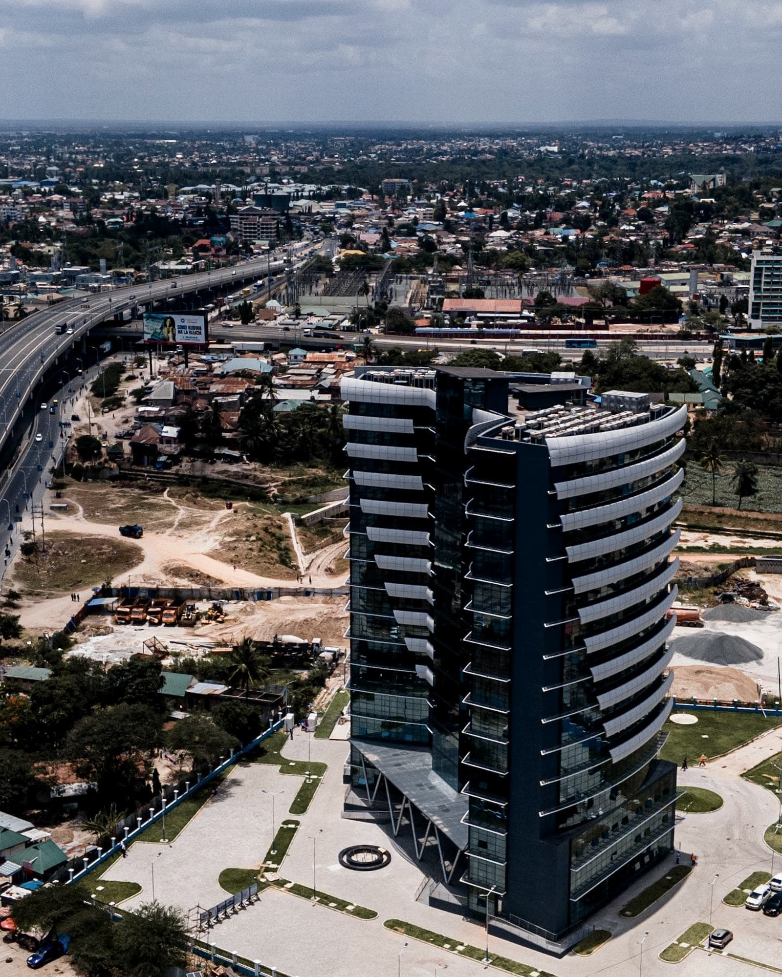 Contemporary commercial office tower in Dar es Salaam — editorial imagery, not a Nextec premises.